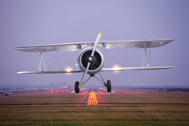 istock Retro plane fly up over takeoff runway at twilight 651260684
