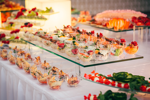 Food Buffet Catering Dining Eating Party Sharing Concept. Multi ethnic people group catering buffet food breakfast indoor in luxury hotel restaurant with meat colourful fruits and vegetables