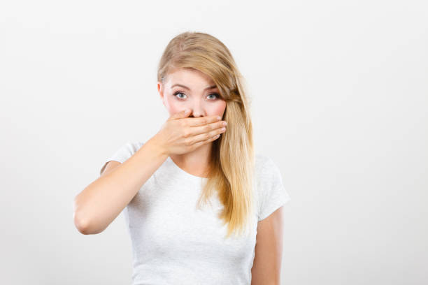 istock Ashamed woman having hand on mouth 651288832