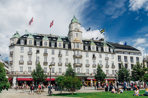 OSLO, NORWAY - JULY 31, 2012: Grand Hotel classical style building with white granite facade and clock tower. Each year the hotel hosts the annual Nobel Peace Prize banquet.