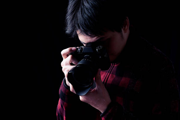 istock Photographer in action with snow on a black background. 651305120