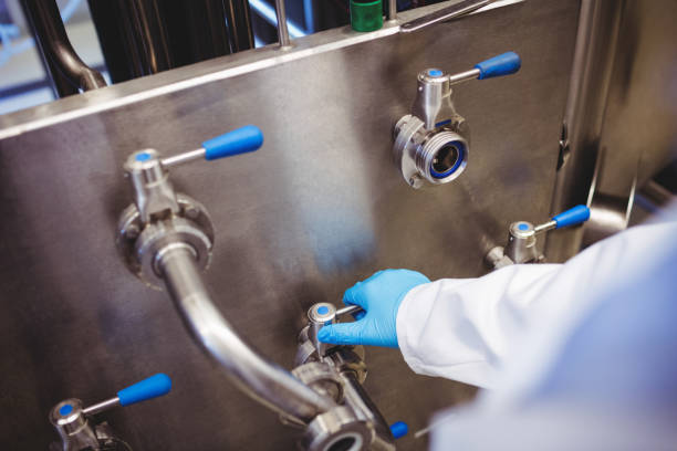 istock Manufacturer adusting pipe at brewery 651312694