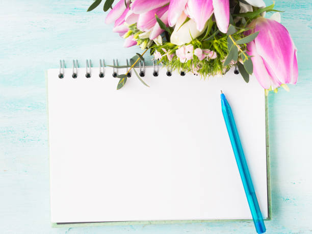 istock Blank notebook page with blue pen and cup coffee flowers 651316006