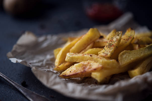 istock French fries on dark background 651316268