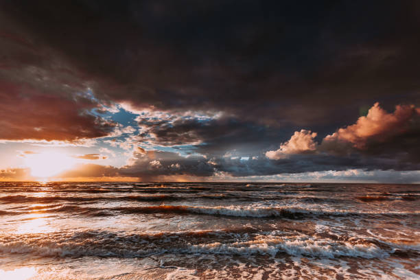 istock Beatiful sunset with clouds over sea and beach 651319876