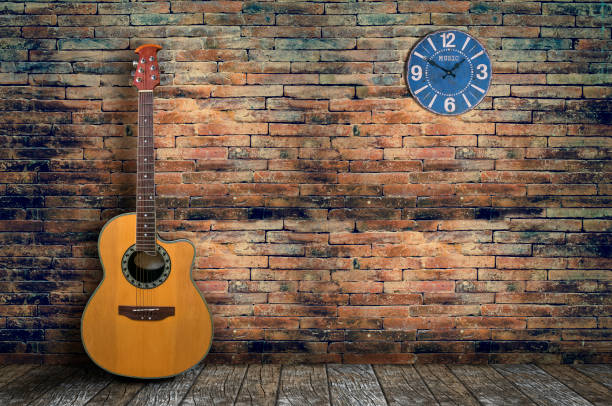 istock acoustic guitar in empty room with  brick wall 651324572