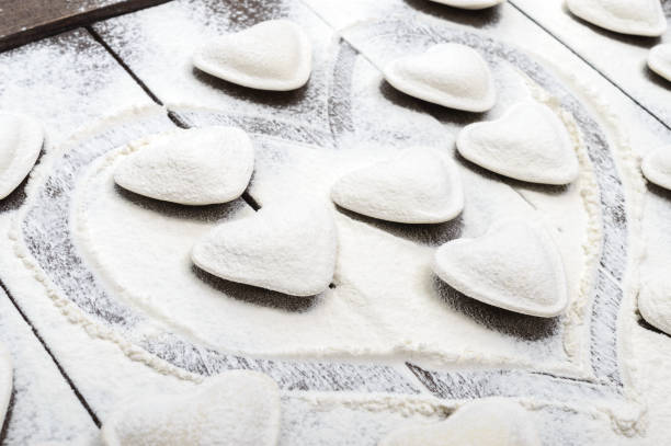 istock Raw dough in the shape of a heart (pierogi, ravioli, dumplings) 651330128