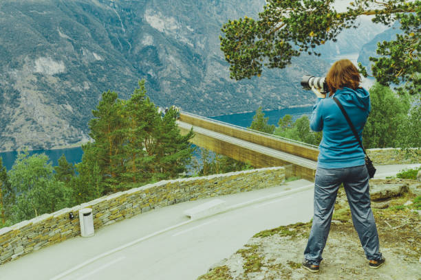 istock Tourist taking photo from Stegastein viewpoint Norway 651334288