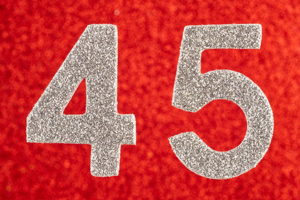 istock Number forty-five silver color over a red background. Anniversary. 651335302