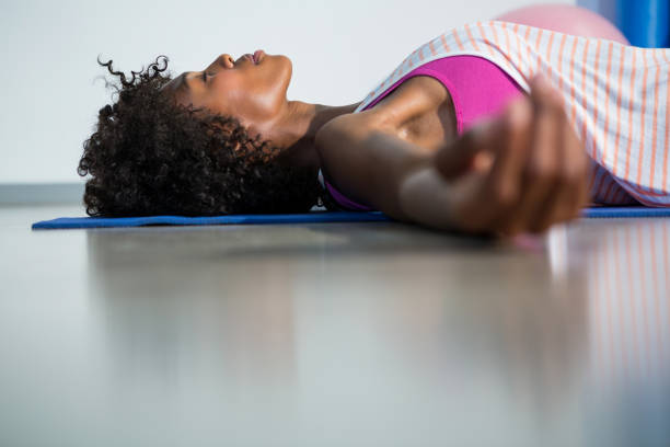 istock Woman in yoga corpse pose 651335418