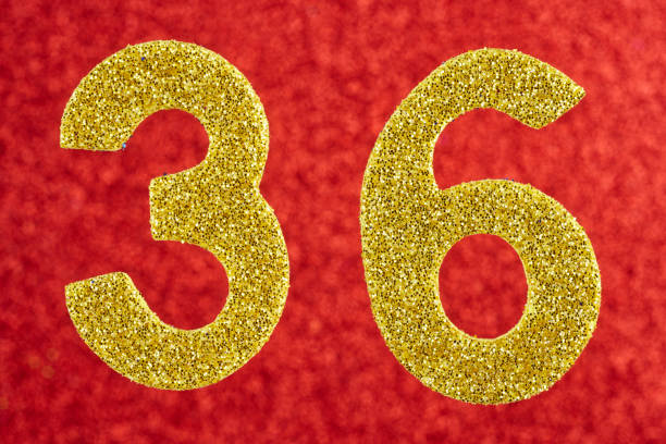 istock Number thirty-six yellow color over a red background. Anniversary. 651335534