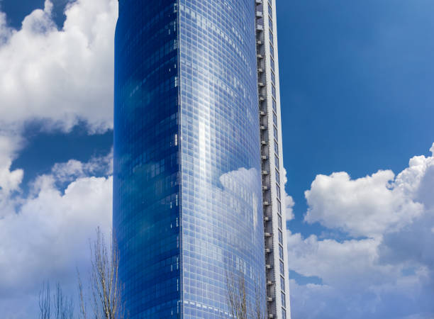 istock Fragment of the office building against the sky with clouds 651335570