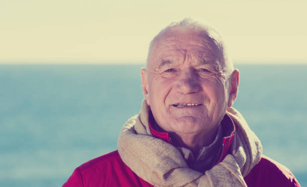 istock Mature man walking by sea 651337714