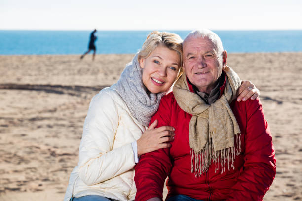 istock Mature couple sitting by sea 651337752