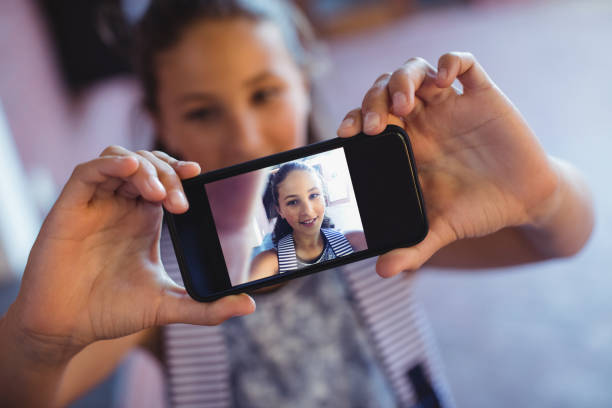 istock Schoolgirl taking selfie on mobile phone 651337804