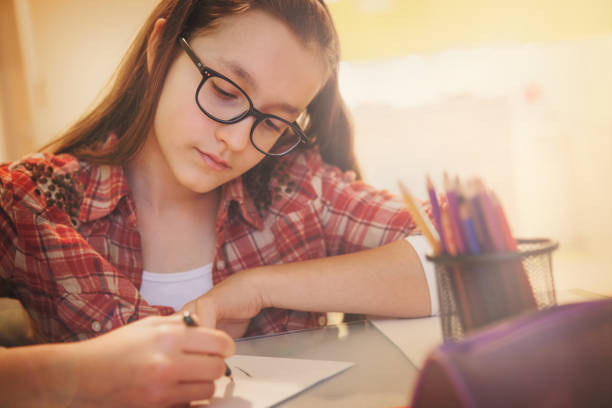 istock Teenage girl doing homework 651338478