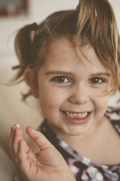 istock Little girl with loose tooth. 651339350