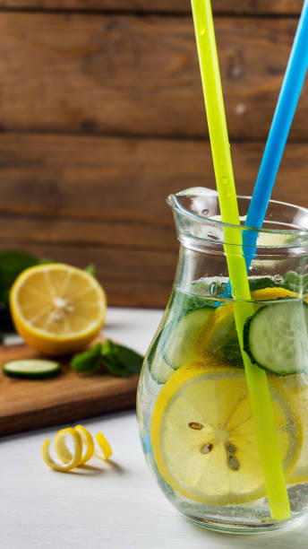 istock Homemade lemon lemonade with cucumber and mint on the rustic background 651341812