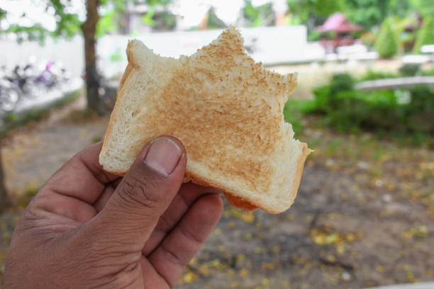 istock Bread slices and jam in hand Close up 651341988