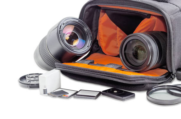 Photo lenses in open camera bag and some photo accessories