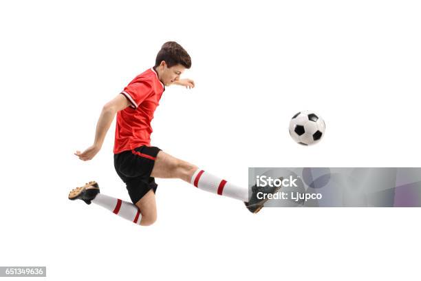 Teenage Soccer Player Kicking A Football Stock Photo - Download Image Now - Soccer Player, Teenager, White Background