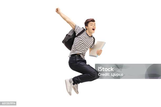 Overjoyed Teenage Student Jumping And Gesturing Happiness Stock Photo - Download Image Now