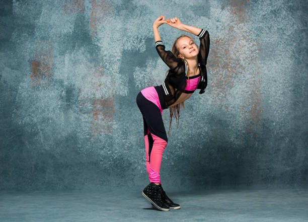 istock Young girl break dancing on wall background 651352200