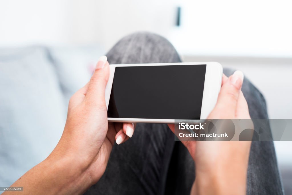 Using smartphone Woman holding smartphone horizontal Movie Stock Photo
