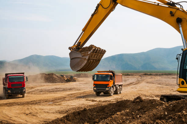 istock Loading of land ground in trucks using excavator 651353990