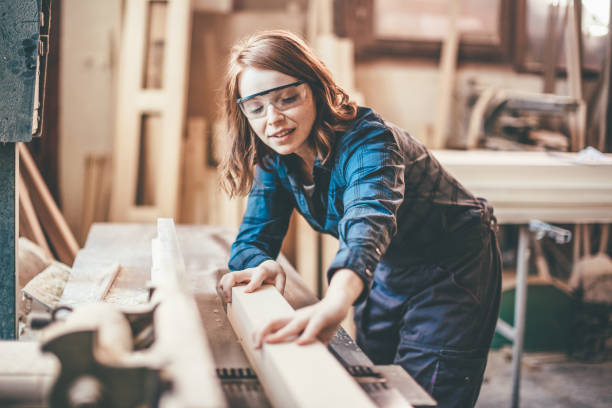 istock Redhead woman cutting a plank 651354038
