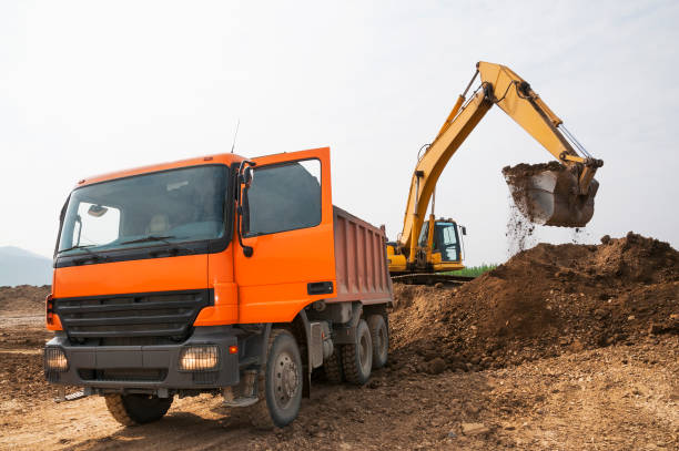 istock Loading of land ground in trucks using excavator 651354074