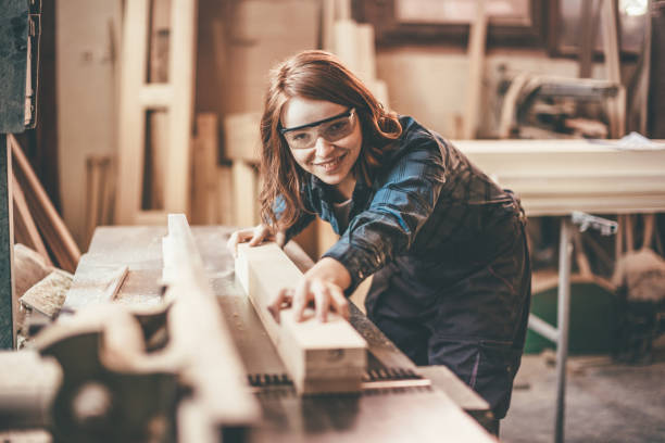 istock woman cutting a plank 651354402
