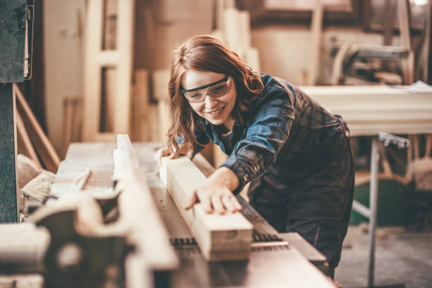 istock Redhead woman cutting a plank 651356994
