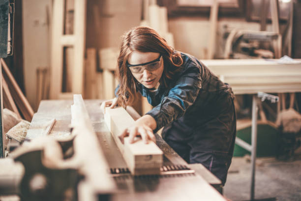 istock woman cutting a plank 651357176