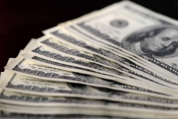 istock A pack of hundred dollar bills on a dark background 651366792