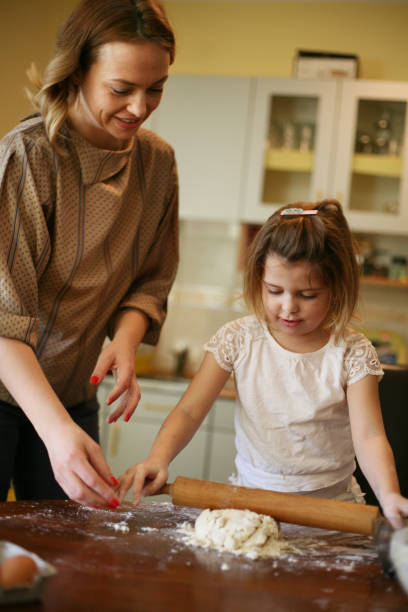 istock Mother and daughter baking. 651376966