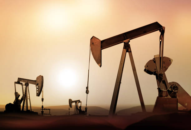 retro oil pumps in deserted district at sunset