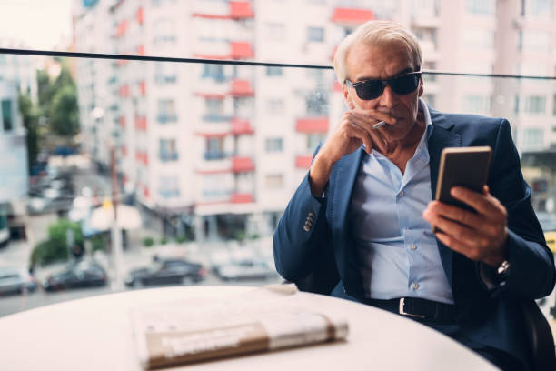 istock Businessman smoking at the building terrace 651435782
