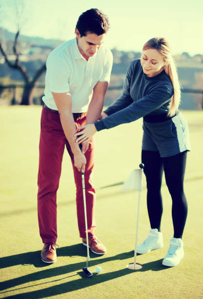 istock Beautiful trainer showing player how to hit ball 651438034