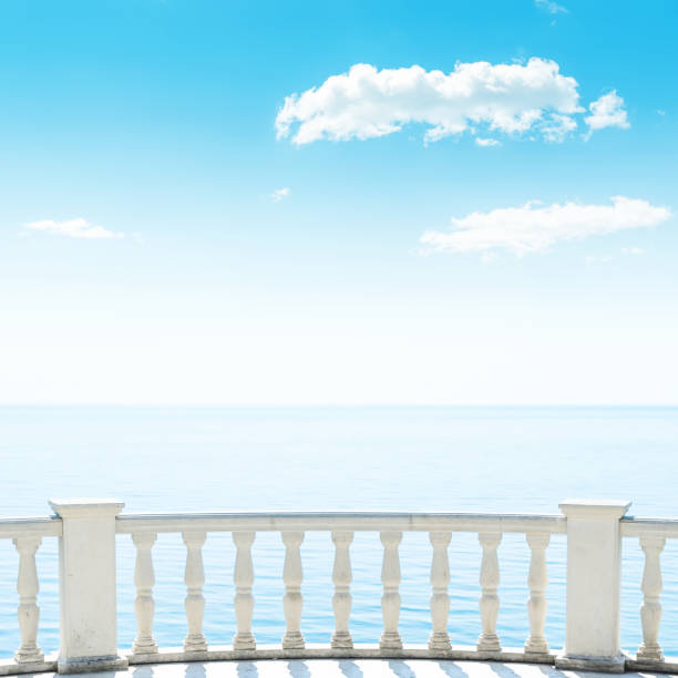 istock balcony over sea and white clouds in blue sky 651438110