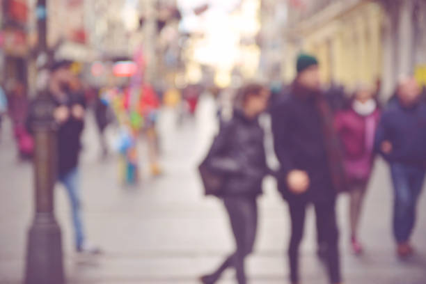 istock Blurred people walking through a city street 651449130