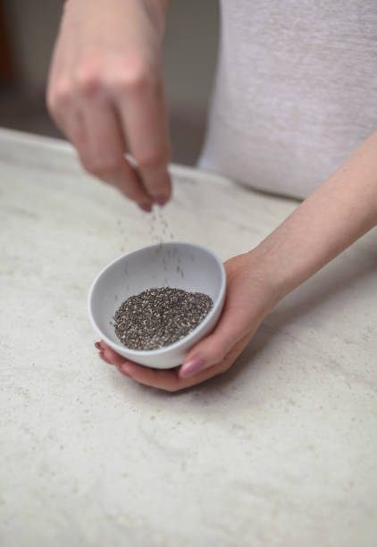 istock Woman Holding Chia Seed Bowl At Counter 651455012