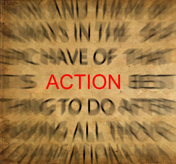 istock Blured text on vintage paper with focus on ACTION 651456124