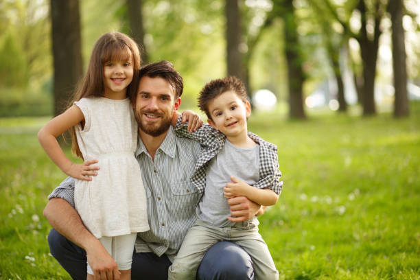istock Cheerful father and small kids enjoying time in nature. 651461812
