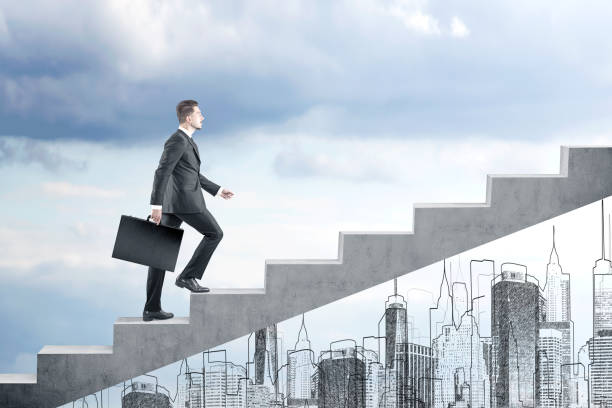 istock Man with suitcase climbing stairs in a cloudy day 651469682