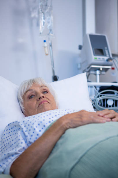istock Worried senior patient lying on bed 651470000