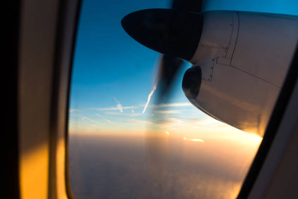 istock Airplane in flight at sunrise 651470506