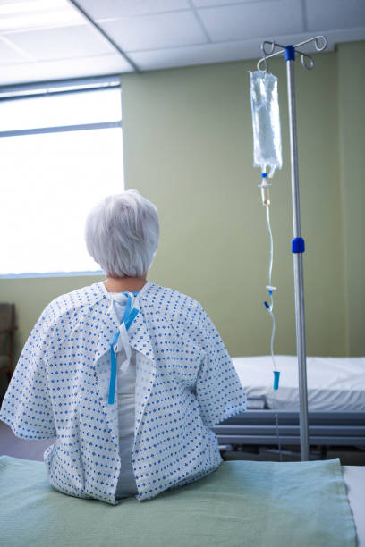istock Rear-view of senior patient sitting on bed 651470830