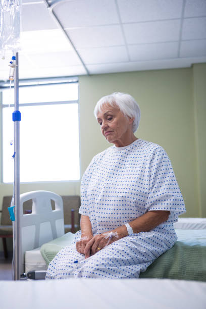 istock Worried senior patient sitting on bed 651471350
