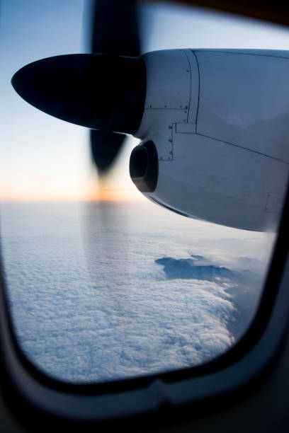 istock Airplane in flight at sunrise 651472186